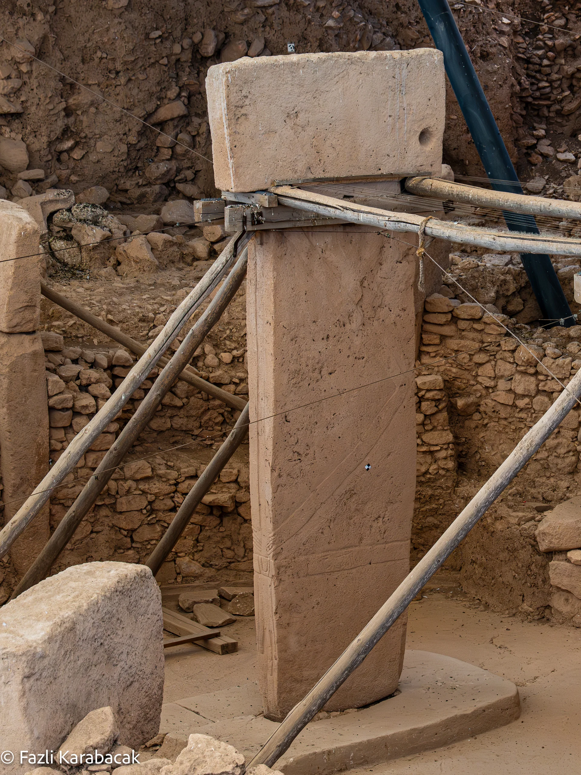 Pillar 18 — carved arms and belt